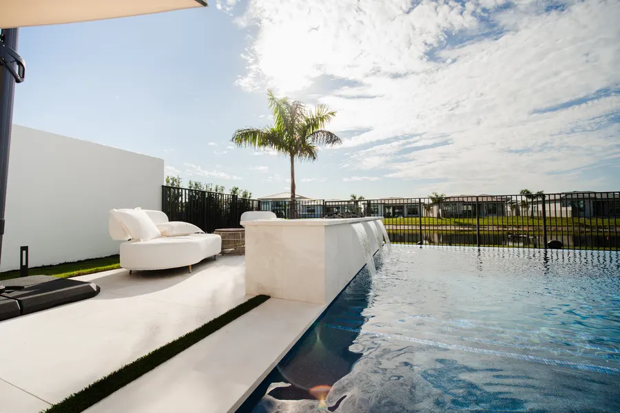 Infinity-edge pool with waterfall wall at a modern South Florida home