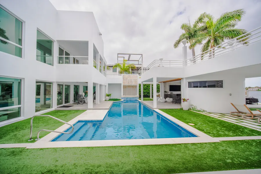 Lap pool framed by a modern courtyard-style residence