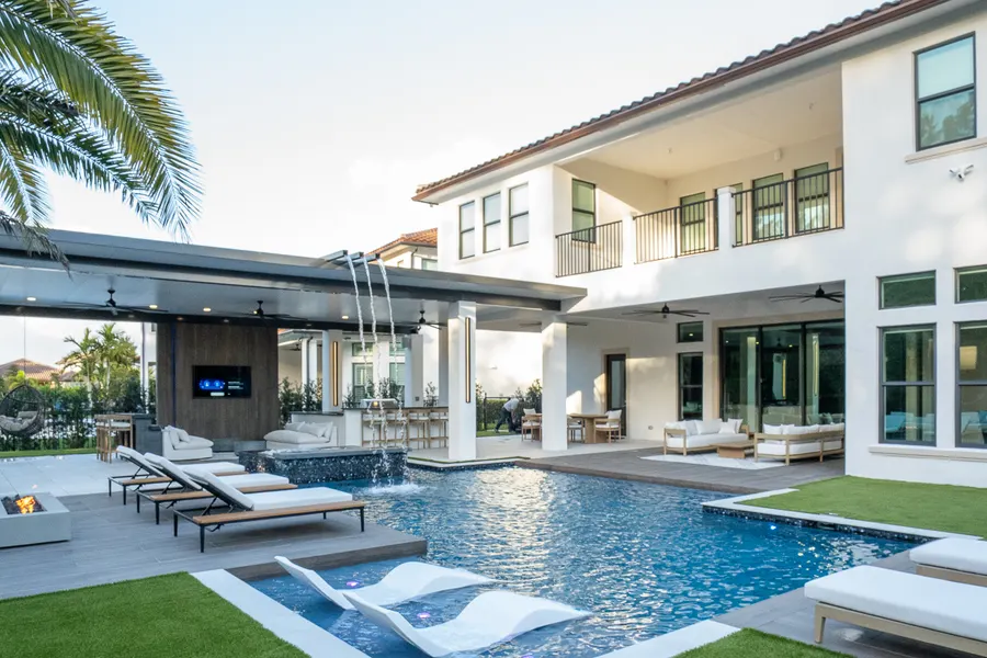 Pool and spa lounge area at twilight with ambient lighting